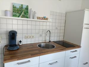 a kitchen with a sink and a counter top at Gemütliche Ferienwohnung in Philippsburg
