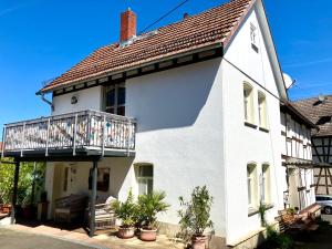 a white house with a balcony at Ferienhaus bei Juste in Schotten