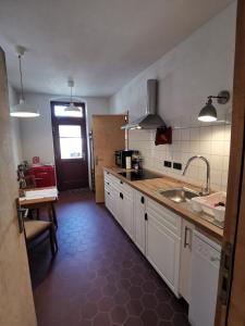 a kitchen with a sink and a counter top at Vielstubenhaus - FeWo August in Pirna