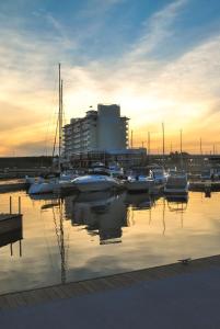 a group of boats docked in a marina at sunset at The Inn at Harbor Shores in Saint Joseph