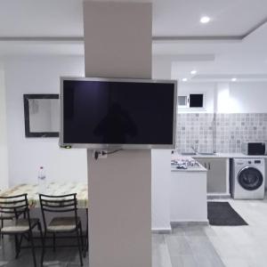a flat screen tv on a pillar in a kitchen at Résidence Rahma in Hammam Chott