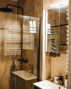 a bathroom with a glass shower and a sink at Feels like home just 10 mins from the centre in Tallinn +23 photos