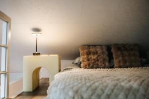 a bedroom with a bed and a table with a lamp at Feels like home just 10 mins from the centre in Tallinn