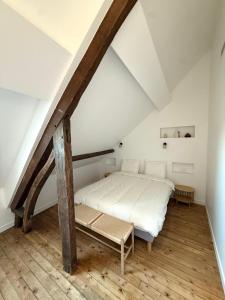 a bedroom with a bed in a attic at Le Clos Langevin in Épernay