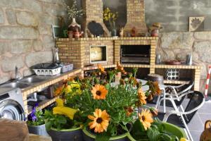 a bunch of flowers in a kitchen with a fireplace at Casa da Aldeia in Penafiel