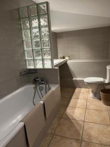 a bathroom with a tub and a toilet at Finca Avrafina in Tarascon +32 photos