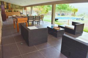 a living room with chairs and a table and a tableablish at Casa da Aldeia in Penafiel