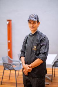 a man in a hat standing in a room at Iconic Polhena in Matara +149 photos
