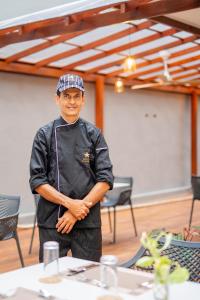 a man standing in a room with his arms crossed at Iconic Polhena in Matara