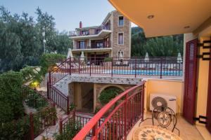 a balcony of a house with a building at GreKa Ionian Suites in Ayia Evfimia