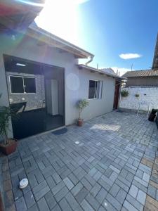 a patio in front of a house at suíte perto da praia in Imbituba