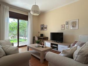 a living room with two couches and a tv at Rhodes Soul Luxury Home in Asgourou