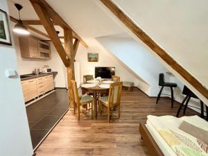 a kitchen and dining room with a table and chairs at Penzion Mlýnický Dvůr in Červená Voda