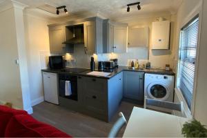 a kitchen with a sink and a washing machine at Character Bedford Apartment with Two Bedrooms in Bedford +7 photos