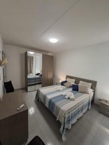 a bedroom with a large bed and a mirror at La casa del delfino in Policoro