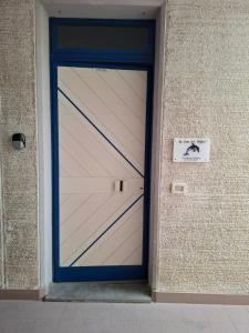 a garage door on the side of a building at La casa del delfino in Policoro