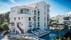 an apartment building with a pool in front of it at Hotel ENAD in Ksamil