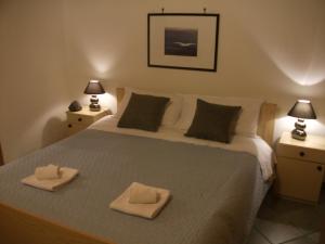 a bedroom with a bed with two towels on it at Villa Davima in Marzamemi