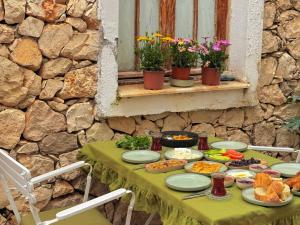 a table with plates of food on it at Old Kalamaki Pansiyon in Kalkan +32 photos