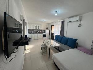 a living room with a couch and a table at Apartmani Natura in Sanski most