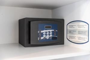 a small television on a shelf next to a sign at Crystal Beach Rooms by PS in Durrës