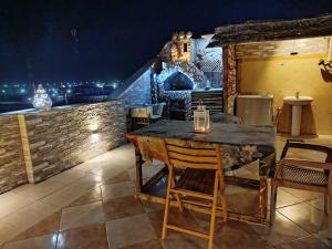 a table and chairs on a patio at night at Chery Private Suite in Marsa Alam City