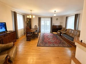 a living room with a couch and a table at Mazurski Dom Sucholaski in Wydminy