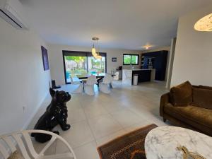 a living room with a couch and a table at VILLA du VERNET avec JACUZZI in Vernet
