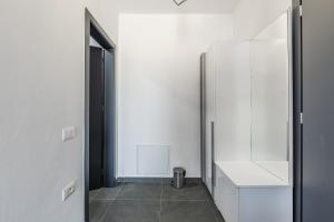 a hallway with a white refrigerator and a door at Crystal Beach Rooms by PS in Durrës +80 photos