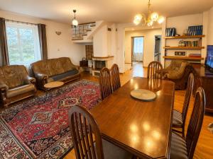 a living room with a table and a couch at Mazurski Dom Sucholaski in Wydminy