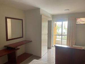 a empty room with a mirror and a window at Eldorado Flat Service Host Hub | Localização Top em frente ao Clube Privé in Caldas Novas +38 photos