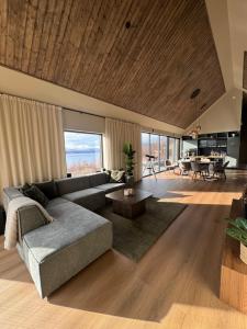 a living room with a couch and a table at LyNora - A private fjord retreat in Indre Ravelseidet +72 photos