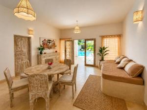 a living room with a table and a couch at Blue Diamond Villa Watamu in Watamu