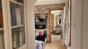 a hallway with a living room with a brick wall at 'Tanglemere' in Broadway