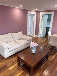 a living room with a couch and a coffee table at Knockeven Hidden Gem in Waterford