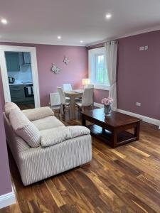 a living room with a couch and a table at Knockeven Hidden Gem in Waterford