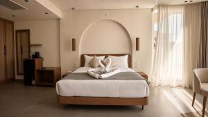 a bedroom with a large bed with two pillows at Selena Bay Beach Resort in Hurghada +39 photos