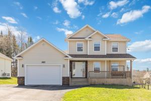 a house with a white garage at Spacious 4BR Family Retreat w- Game Room 10p in Dieppe