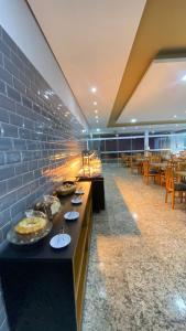 a restaurant with a buffet line with food on it at Hotel Abba Goiana PE in Goiana