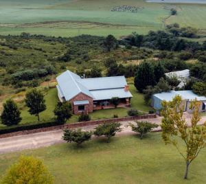 an aerial view of a house with a barn at Highveldt Farm, Nottingham Road in Fort Nottingham