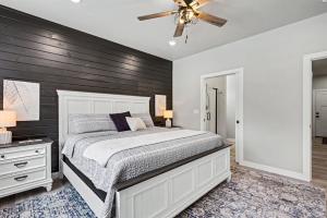 a bedroom with a bed and a ceiling fan at Four Sisters Cottage- Walk to Sister Bay, Fireplace, Ping Pong & More in Sister Bay