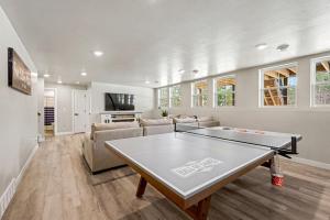 a living room with a ping pong table in it at Four Sisters Cottage- Walk to Sister Bay, Fireplace, Ping Pong & More in Sister Bay