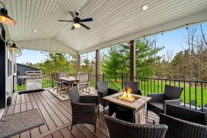 a patio with a table and chairs and a fire pit at Four Sisters Cottage- Walk to Sister Bay, Fireplace, Ping Pong & More in Sister Bay