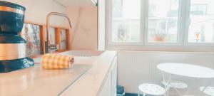 a kitchen with a counter top with a towel on it at PARIS AUTHENTIC HOUSE Métro 7 Pierre et Marie Curie in Paris +97 photos