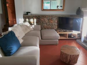 a living room with a couch and a tv at Monte do Rei Santo in Arronches