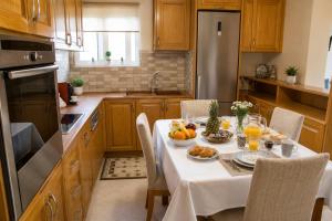 a kitchen with a table with fruit on it at ATH Airport Suites Free Shuttle From And To Athens Airport in Spata