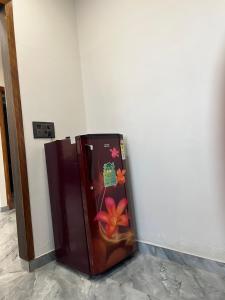 a brown refrigerator with a painting on the side of a wall at Aura Villa in Ghaziabad