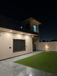 a night view of a house with a lawn at Aura Villa in Ghaziabad