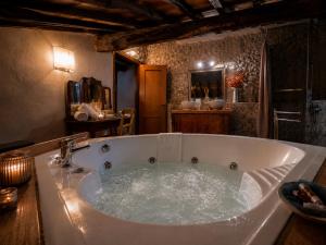 a large bath tub in a room with at LA MORA Exclusive in Moricone