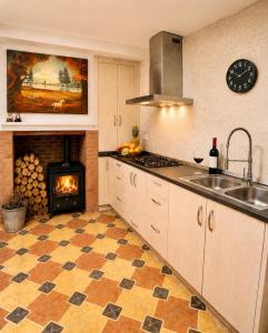 a kitchen with a stove and a fireplace at Casa Rural San Gregorio in Alcalá del Júcar